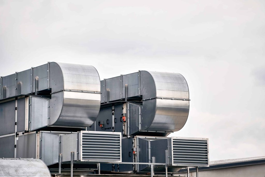 Close-Up View of Commercial HVAC Ventilation System on Rooftop. Air condition system on the building rooftop. Air conditioner compressor on a rooftop. Sustainable heating solution.